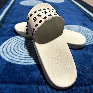 Guess white sandals with black details.